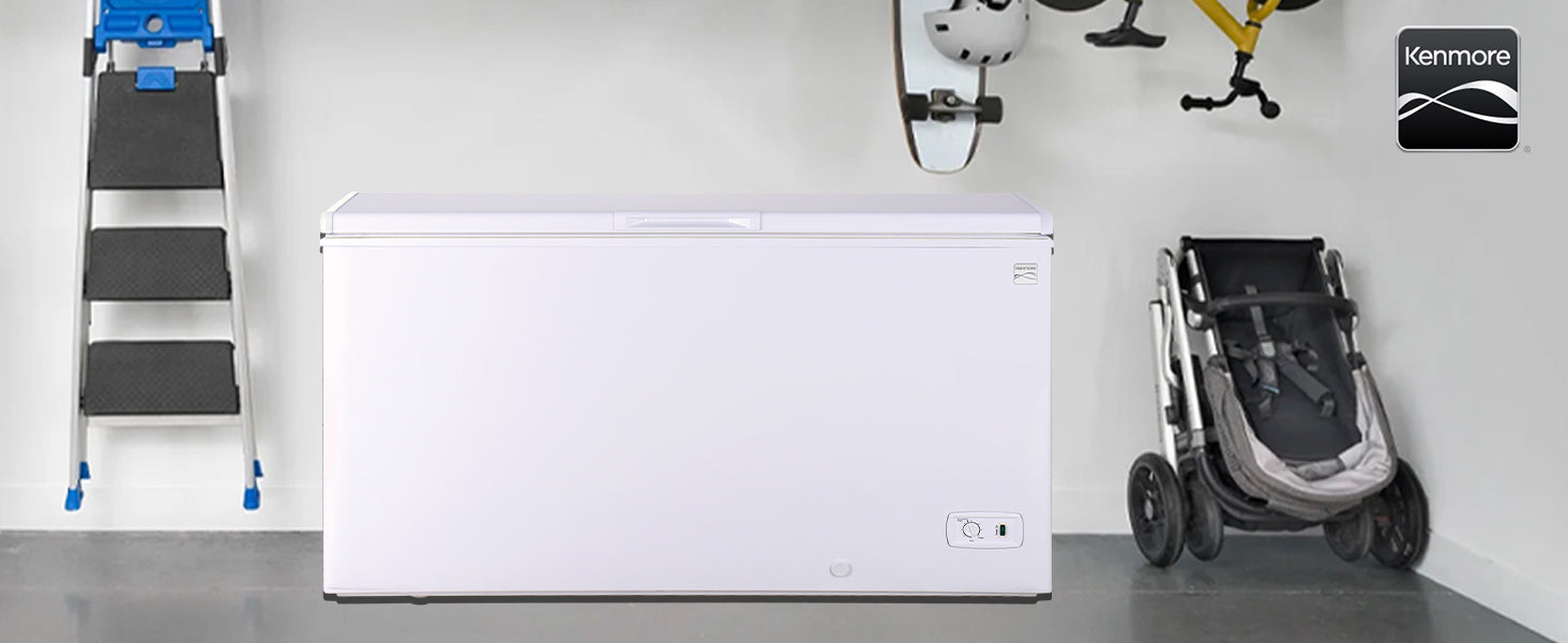 Kenmore 14.6 cubic foot chest freezer in a garage between a folded ladder and a stroller