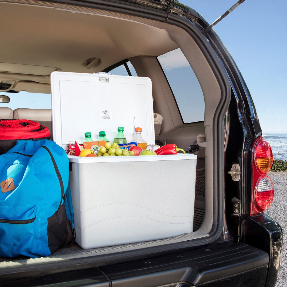33 Litre !2 v cooler, plugged into trunk of SUV, Besides ablue backpack.