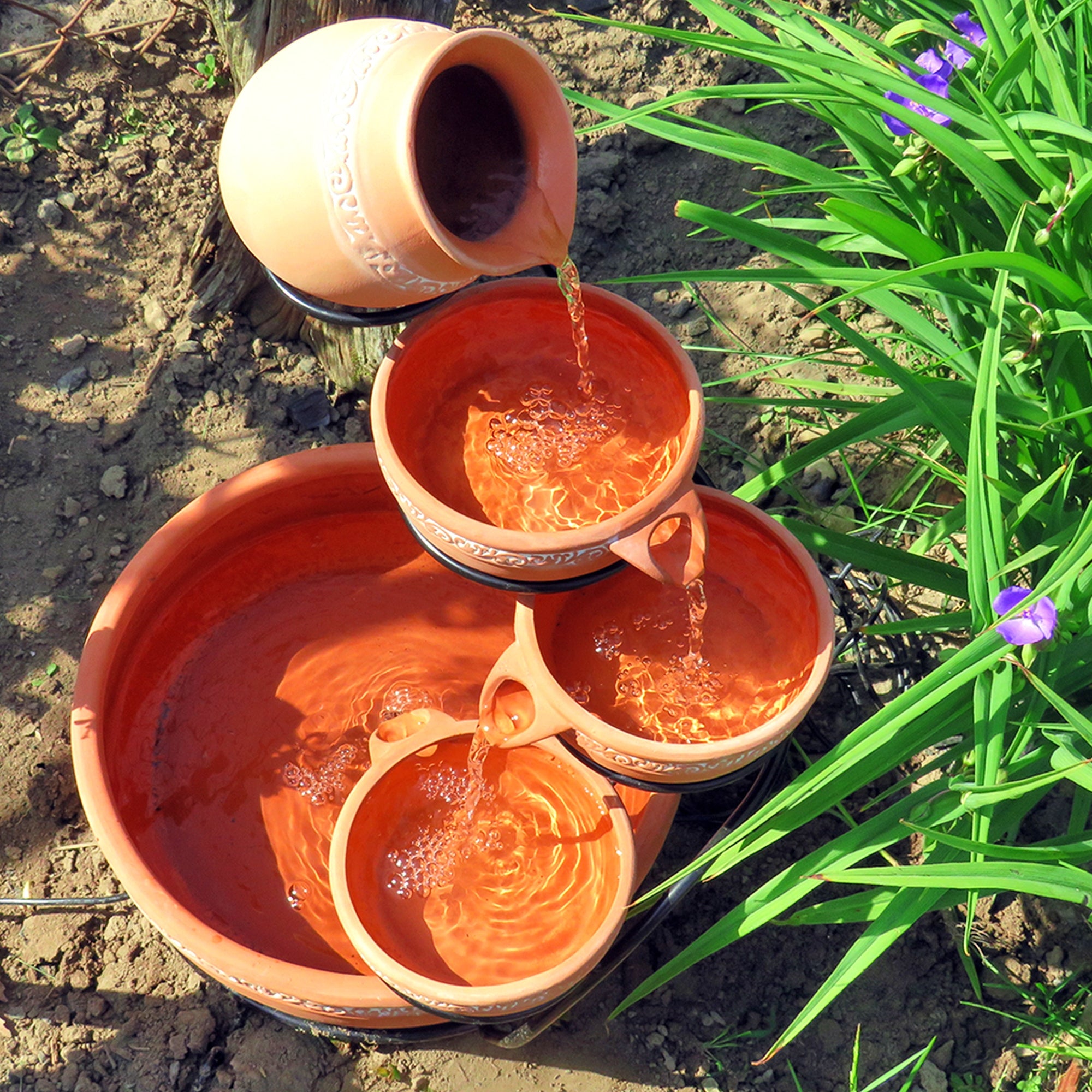 Koolscapes terracotta solar fountain with water running set up on a garden and viewed from above