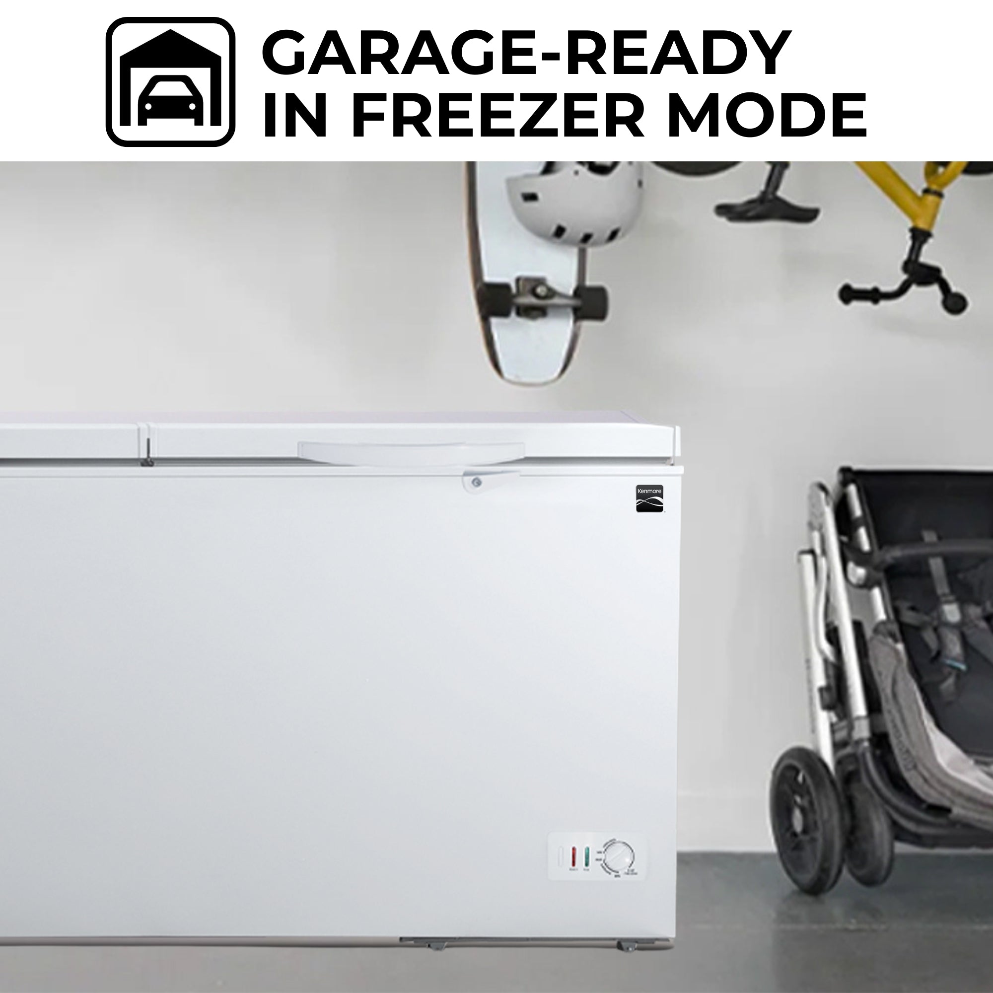 Kenmore convertible chest freezer, closed, in a light gray garage with a skateboard and bicycle hanging above and a folded stroller to the right. Text above reads, "Garage-ready in freezer mode"