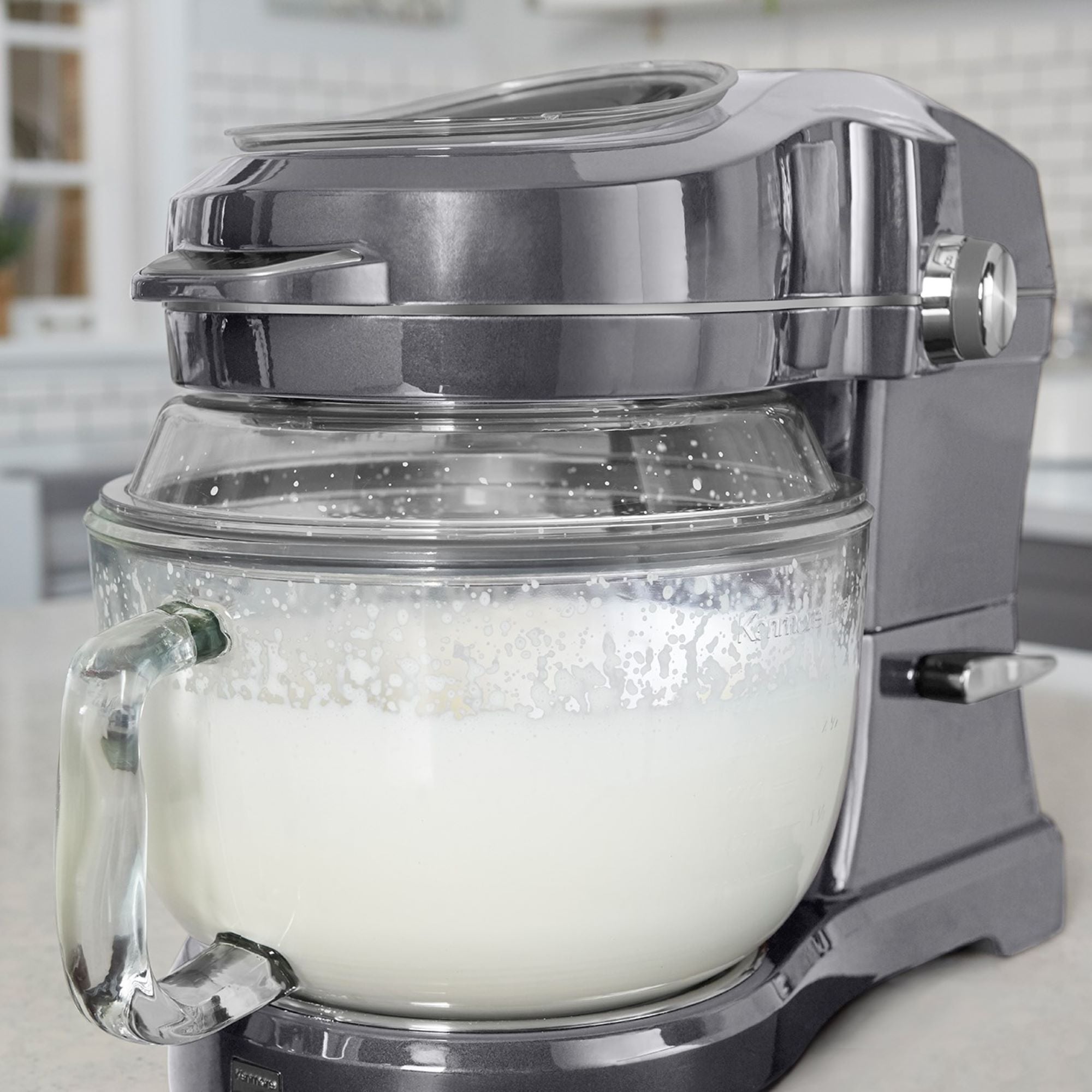 Closeup of the Kenmore Elite Ovation mixer with the bowl filled with cream