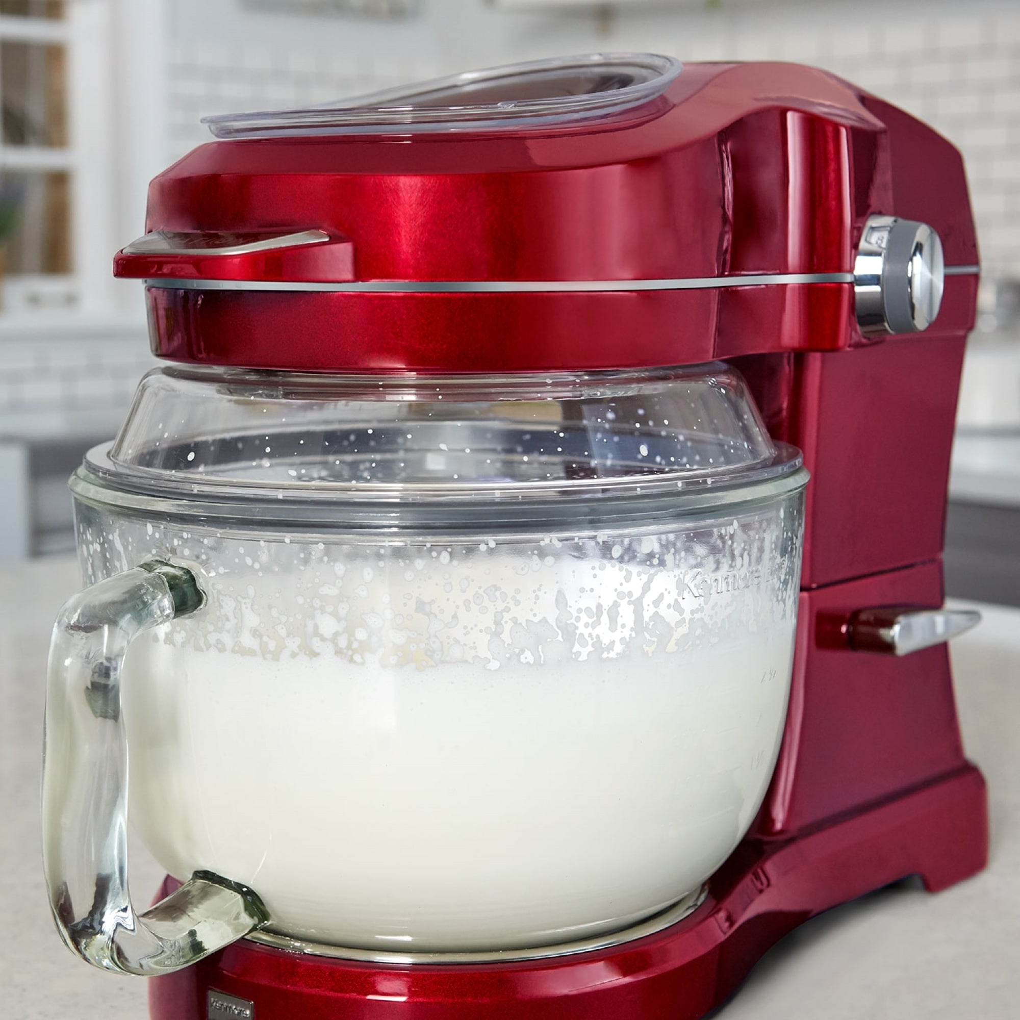 Closeup of the Kenmore Elite Ovation mixer with the bowl filled with cream