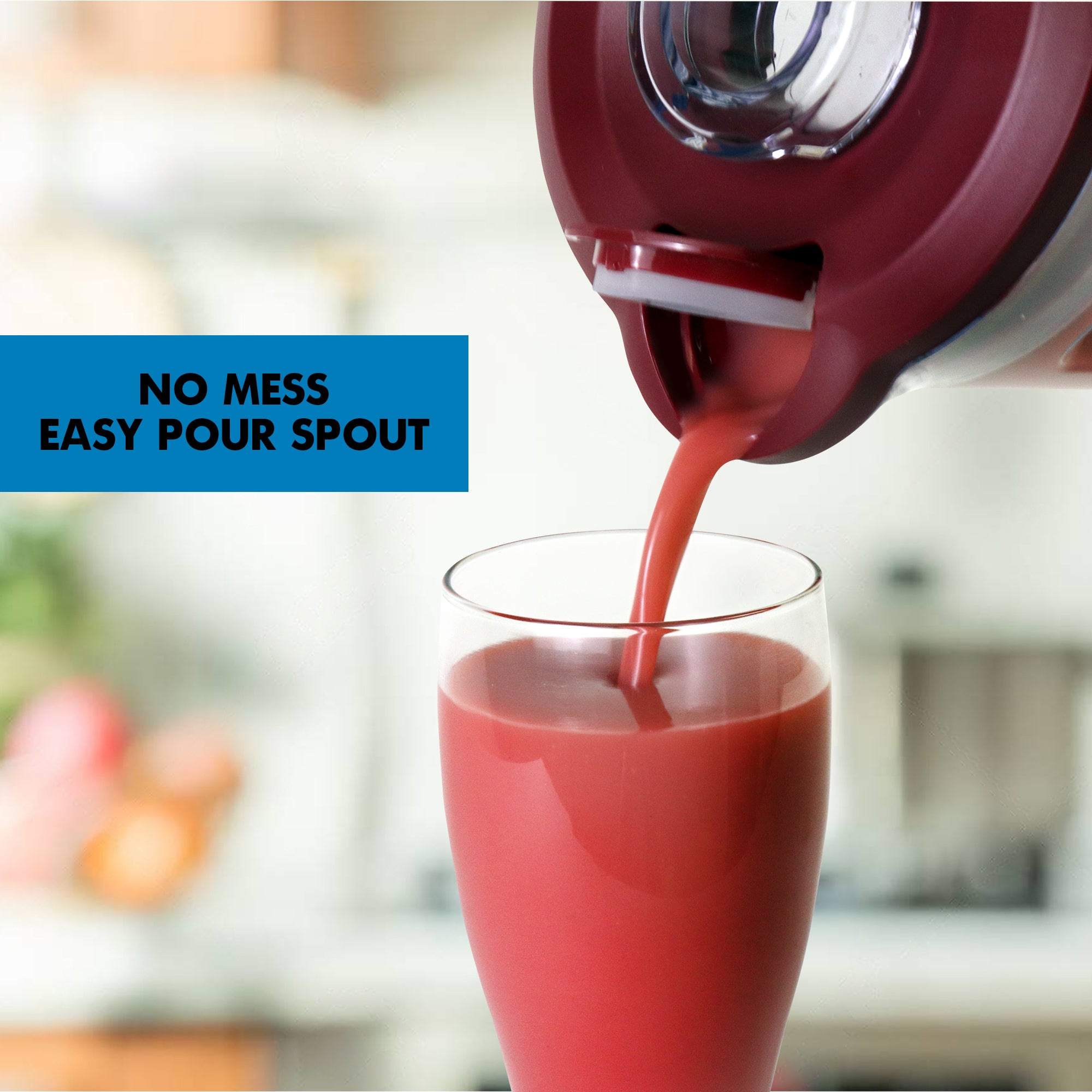 Closeup of bright pink smoothie pouring out of the blender's flip-top spout into a glass with text overlay reading No mess easy pour spout.