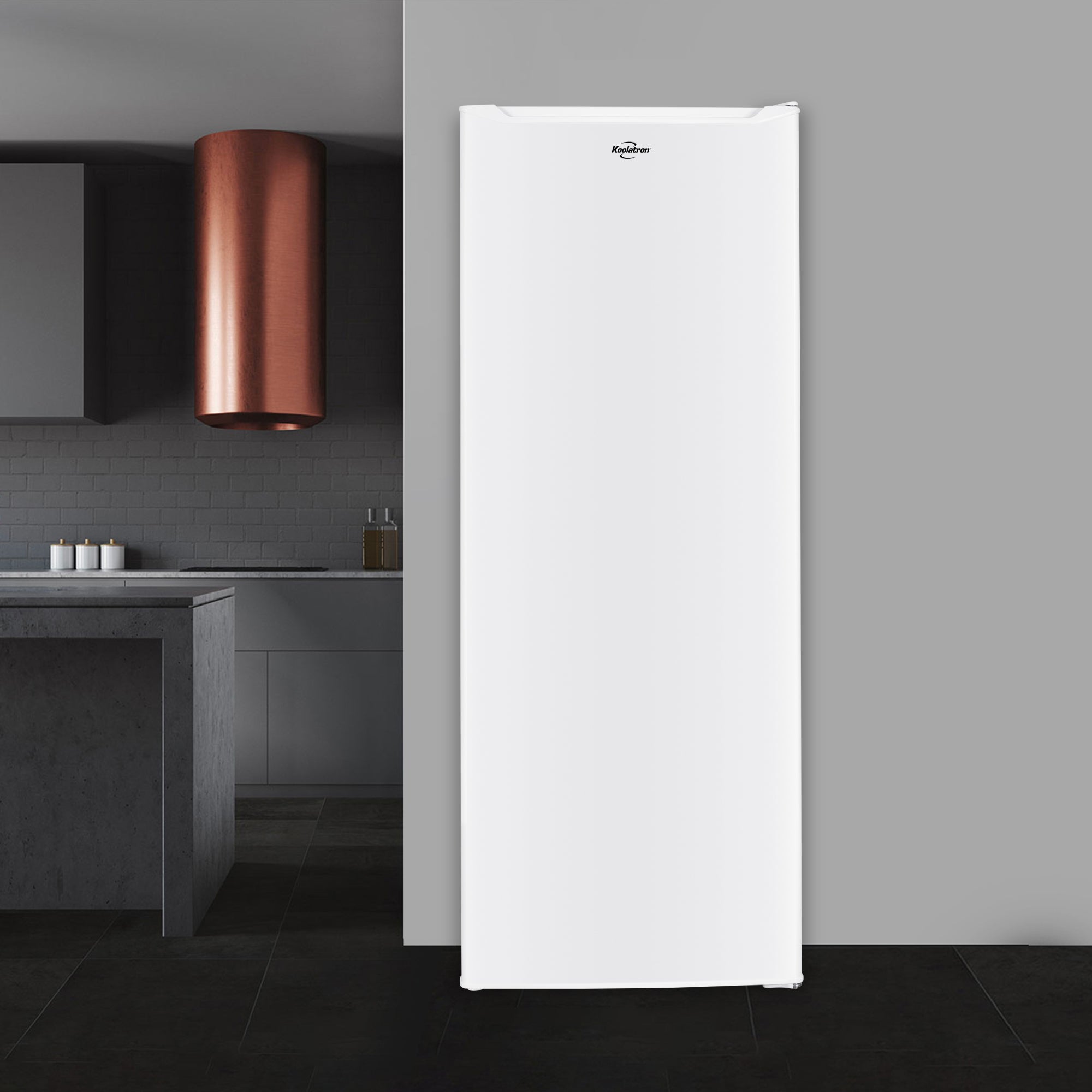 Koolatron compact upright freezer, closed, in a modern dark gray kitchen.